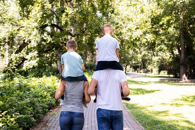 I genitori portano i loro figli sulle spalle