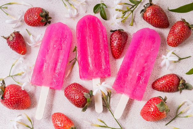 Il gelato alla fragola su bastoni aromatizza sulla tavola