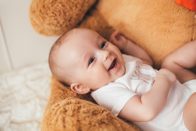 Il piccolo bambino giace sull&#39;orso