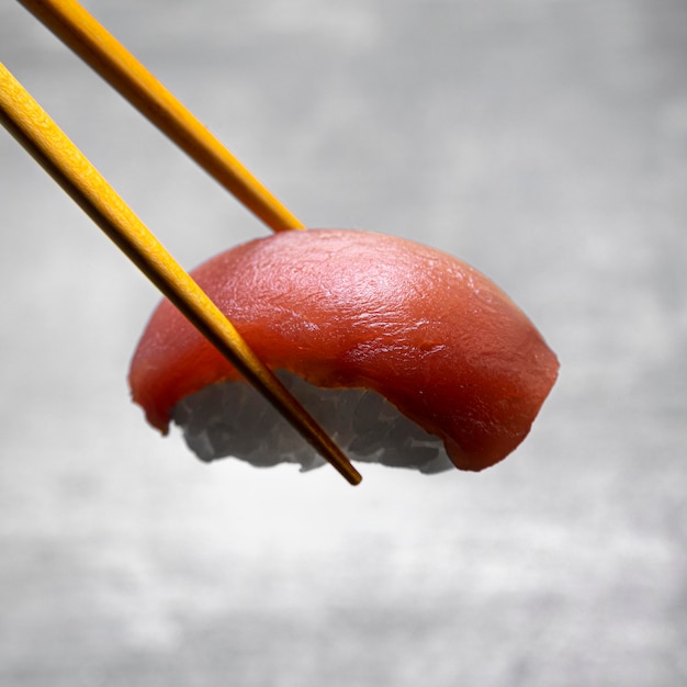 Il primo piano attacca che tiene pesce con riso