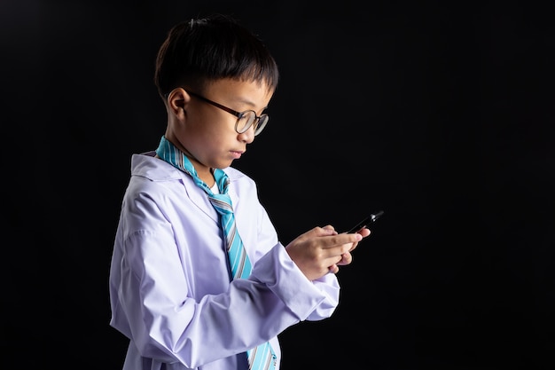 Il ragazzo asiatico imita l'adulto con lo smartphone