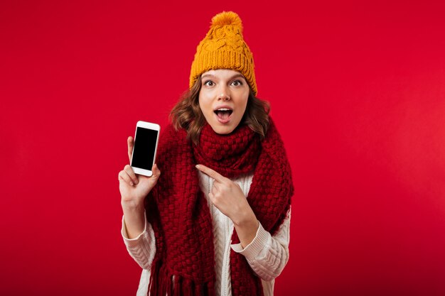 Il ritratto di una ragazza sorpresa si è vestito in cappello dell'inverno