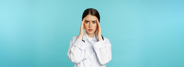 Immagine di donna medico personale medico che fa una smorfia per il disagio che ha mal di testa sensazione di emicrania de