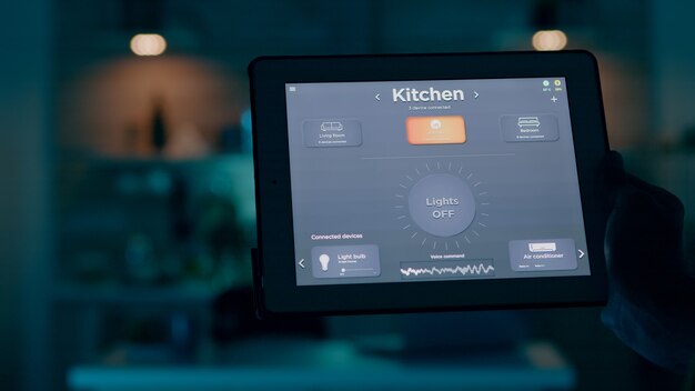 Immagine ravvicinata di tablet con applicazione smart home attiva detenuta da man