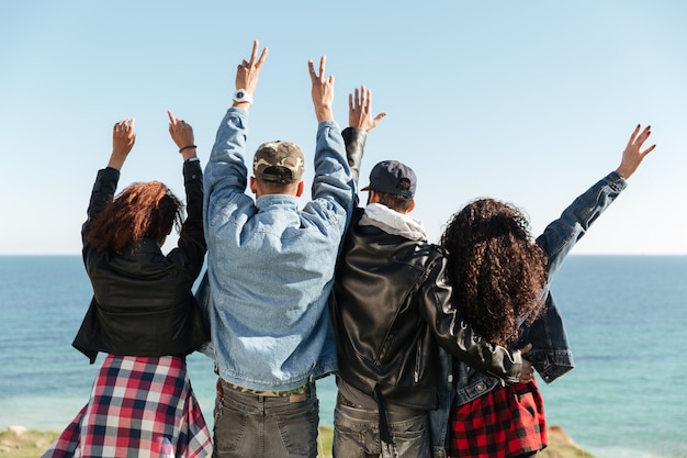 Immagine vista posteriore di un gruppo di amici in piedi all'aperto