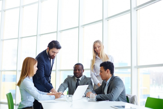 Imprenditori che lavorano come una squadra con il computer portatile