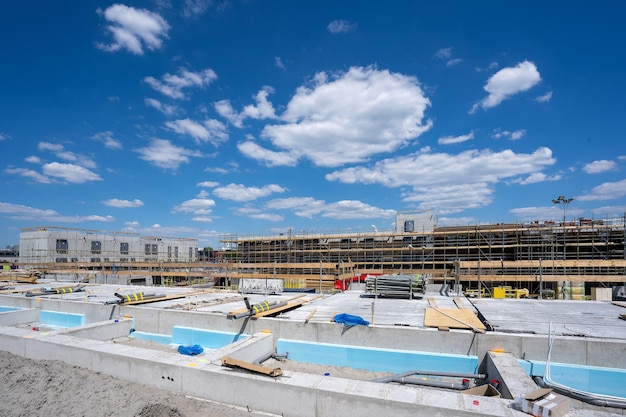 Inquadratura orizzontale di un cantiere con ponteggi sotto il cielo blu chiaro