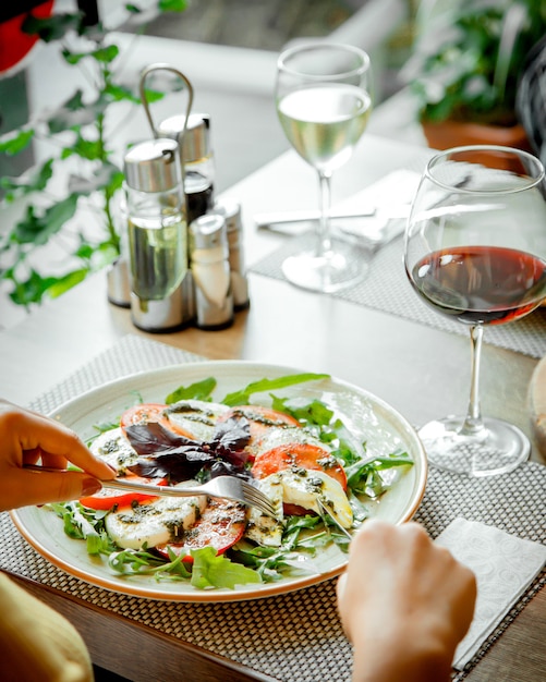 Insalata Caprice e un bicchiere di vino rosso