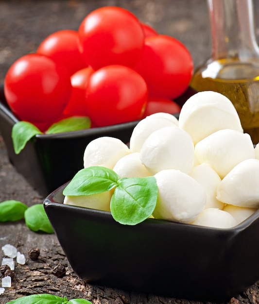 Insalata fresca con pomodorini, basilico, mozzarella e olive nere.