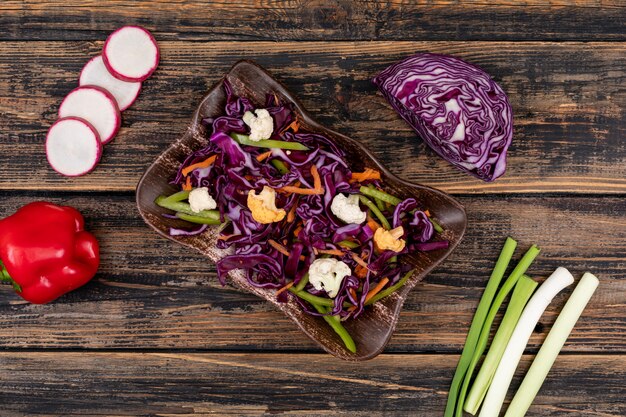 insalata fresca di forma fisica della vitamina di cavolo rosso in zolla su di legno