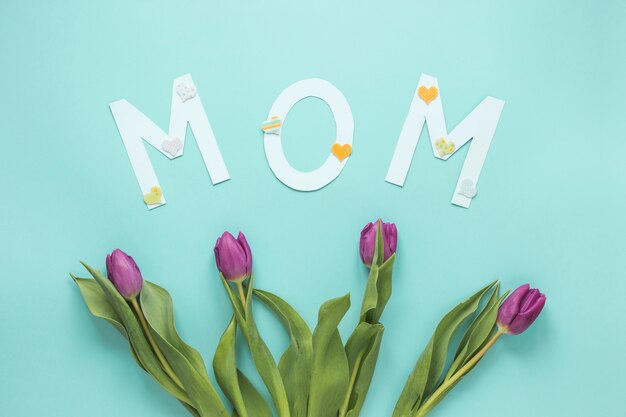 Iscrizione di mamma con tulipani sul tavolo