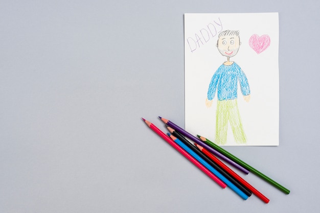 Iscrizione di papà con disegno di uomo e matite