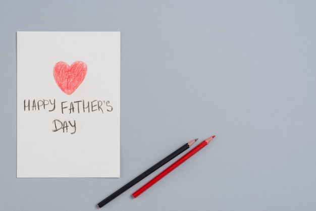 Iscrizione felice di giorno di padri sullo strato di carta con le matite