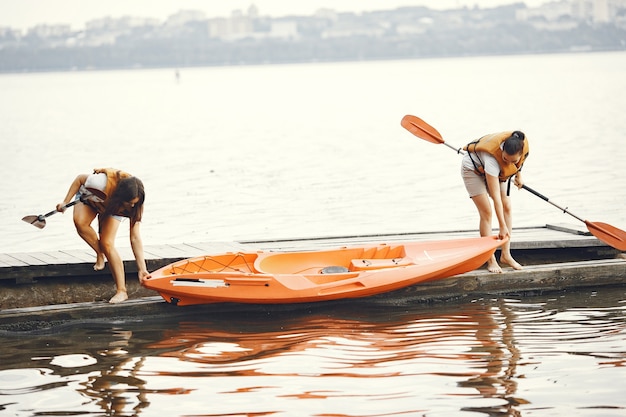 Kayak. Una donna in kayak. Le ragazze si preparano all'imbottitura su un lago.