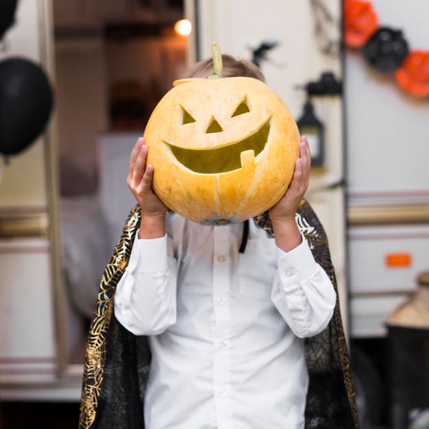 Kid holding zucca intagliata