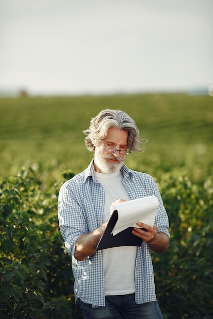 L'agricoltore esamina il campo. Agronomo o agricoltore esamina la crescita del grano.