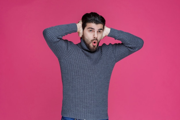 L'uomo con la barba nera sembra esausto e annoiato.