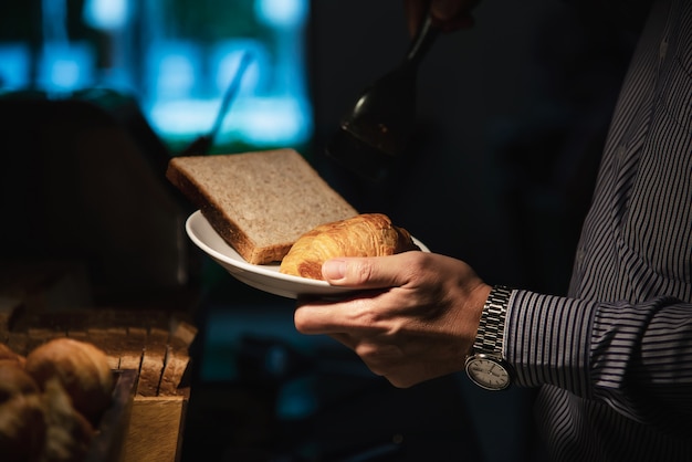 L'uomo di affari mangia la prima colazione americana messa in un hotel