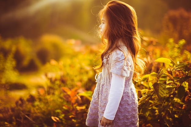 La bambina con il supporto rosso dei capelli sta sul campo