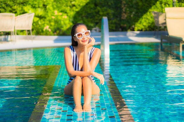 La bella giovane donna del ritratto si rilassa il tempo libero di sorriso in vacanza intorno alla piscina nell'hotel della località di soggiorno