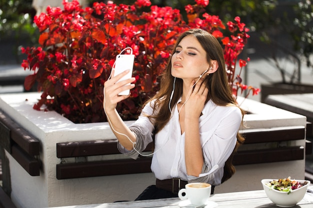 La donna parla via le cuffie sul telefono