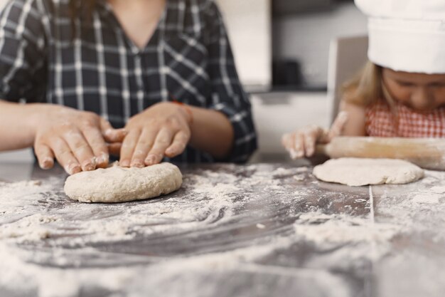 La famiglia in una cucina cucina la pasta per i biscotti