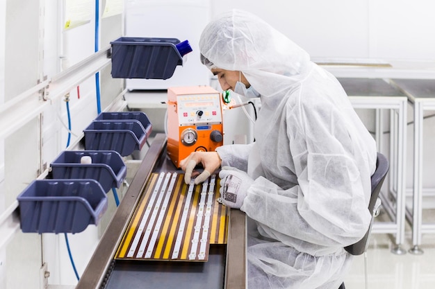 La gente in costumi d&#39;isolamento bianchi che lavorano in laboratorio