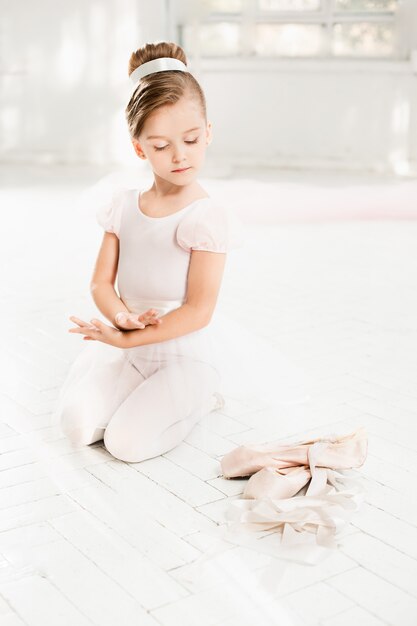 La piccola balerina in tutù bianco in classe alla scuola di balletto