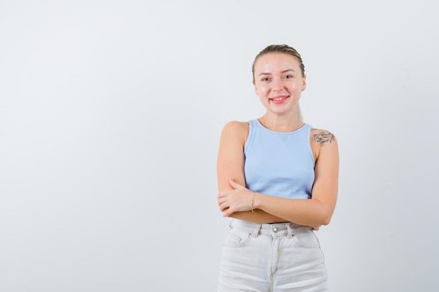 la ragazza in piedi tranquillamente sta posando alla macchina fotografica su priorità bassa bianca