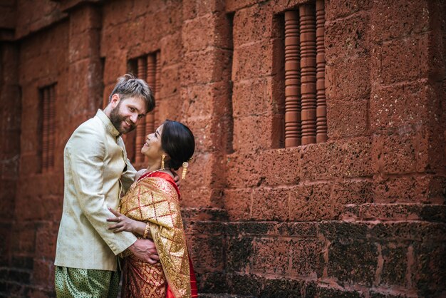 La sposa asiatica e lo sposo caucasico hanno tempo romantico con il vestito della Tailandia