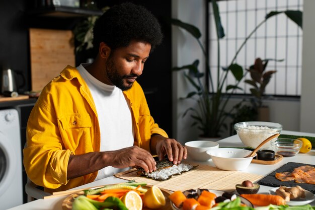 La vista delle persone che imparano a preparare il tradizionale piatto di sushi