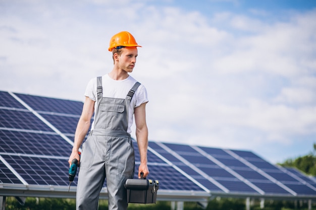 Lavoratore uomo nel firld dai pannelli solari