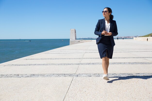 Lavoro di ufficio positivo che ammira vista sul mare