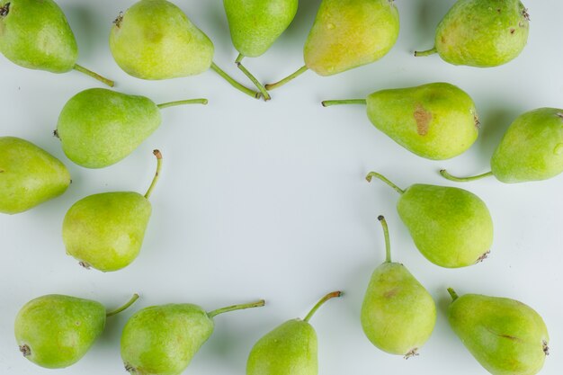 Le pere fresche piatte giacciono su uno sfondo bianco