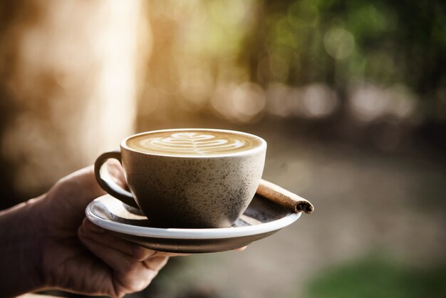 Le persone servono una bella e fresca tazza di caffè al mattino