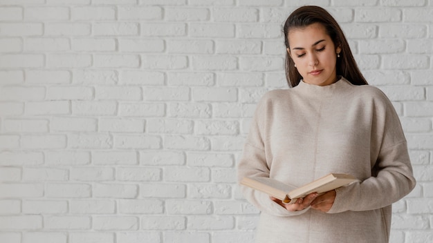 Lettura della donna del colpo medio con lo spazio della copia