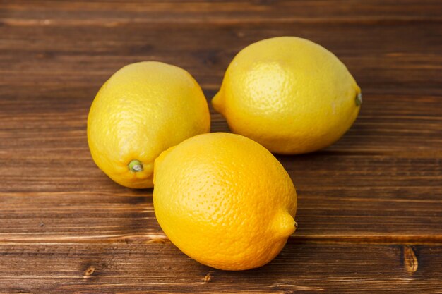 Limoni gialli su una superficie di legno. vista dall'alto. copia spazio per il testo