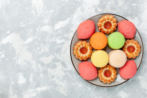 Macarons francesi vista dall'alto con biscotti su superficie bianca chiara