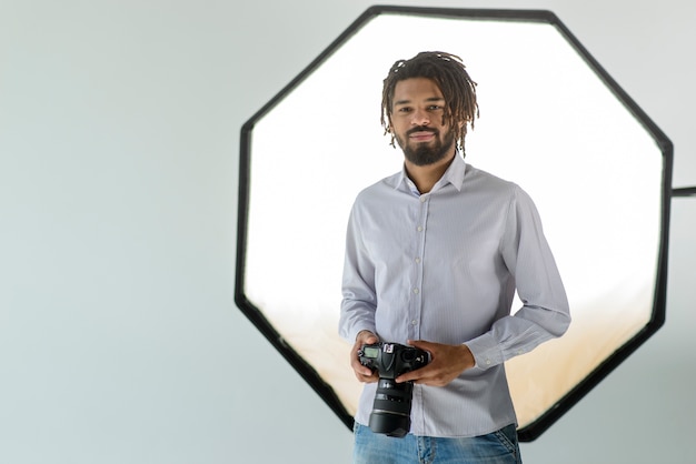 Macchina fotografica della tenuta dell'uomo del colpo medio