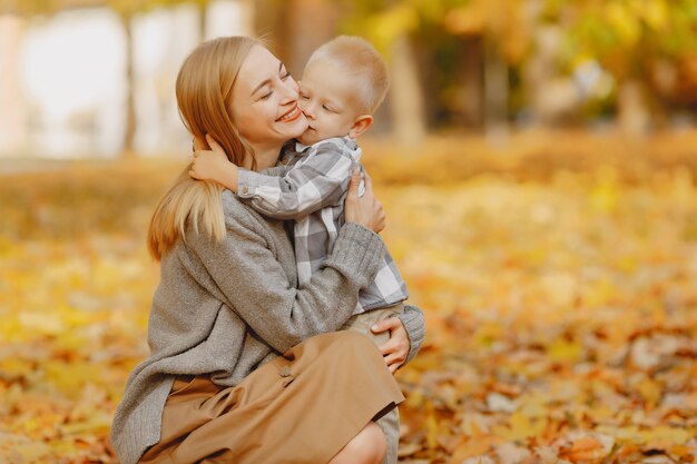 Madre con figlio piccolo, giocando in un campo in autunno