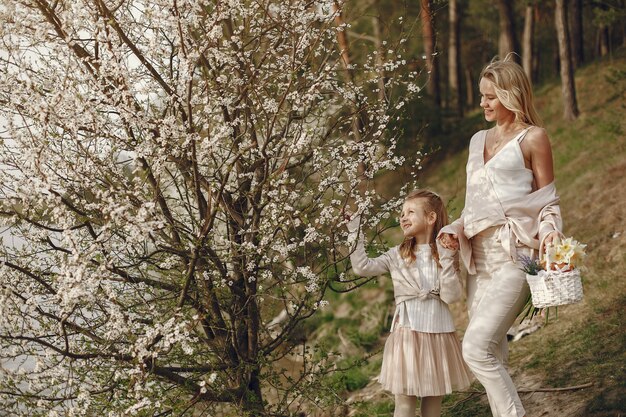 Madre con la figlia in una foresta di estate