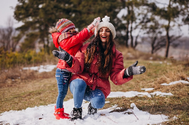 Madre con la piccola figlia in una foresta di inverno