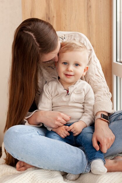 Madre dell'angolo alto che bacia figlio