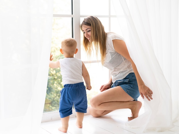 Madre della foto a figura intera che sorride al figlio