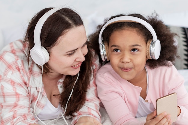 Madre e figlia felici che ascoltano la musica