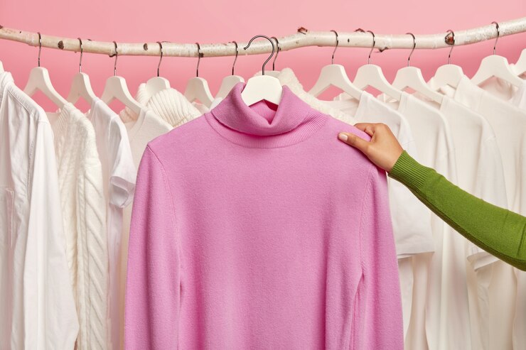 Foto gratuito maglione casuale viola sui ganci in mano della donna contro la guida con vestiti bianchi come la neve.