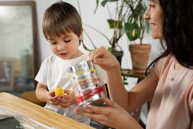 Mamma che mostra al bambino come riutilizzare i materiali in modi creativi