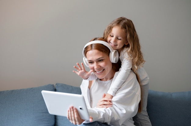 Mamma fa una videochiamata di famiglia con sua figlia