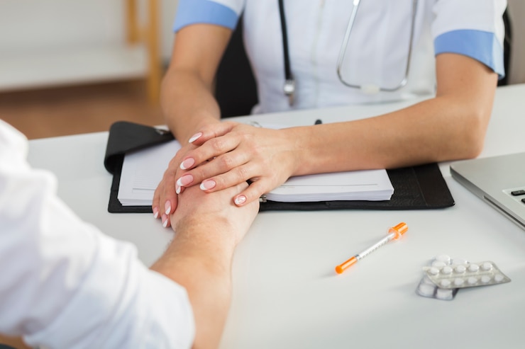 Foto gratuito mani femminili del medico che tengono la mano paziente