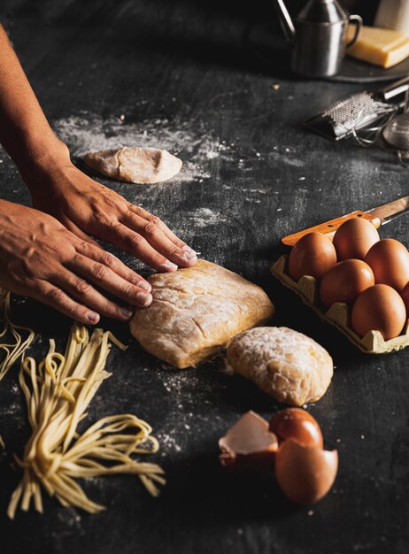 Mani ravvicinate con pasta e uova